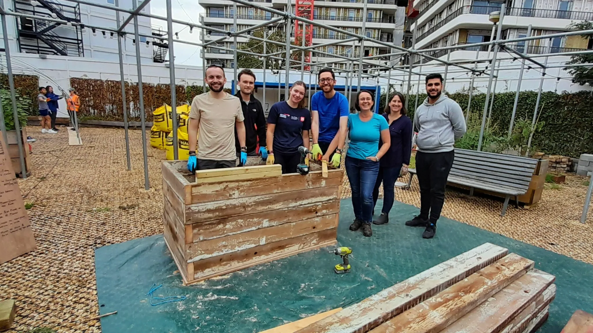 Team members assembling sustainable garden furniture from reclaimed wood at Ebury Bridge Estate